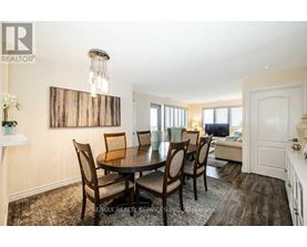 A dining room with a table set for four.