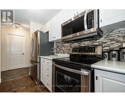 A kitchen with a stove top oven and microwave above it.