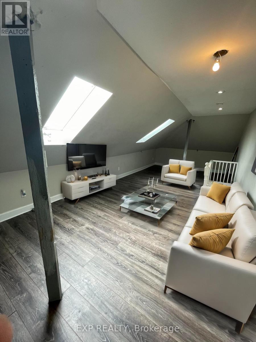 A living room with a couch, coffee table, and skylight.
