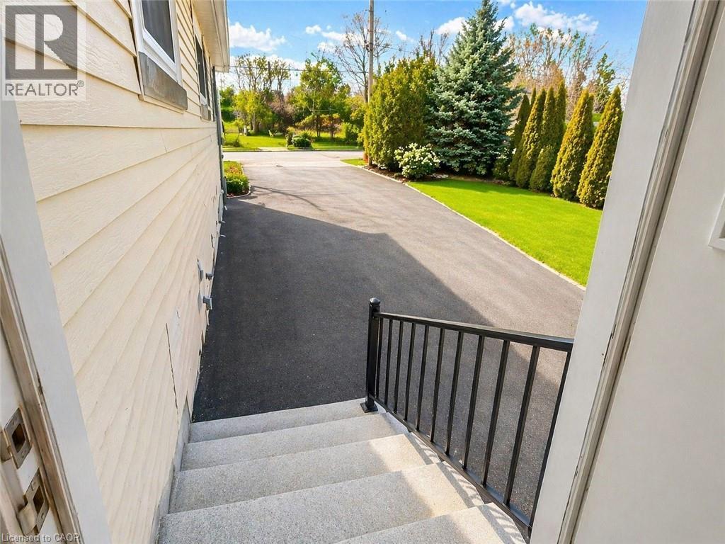 A house with a driveway and a black railing.