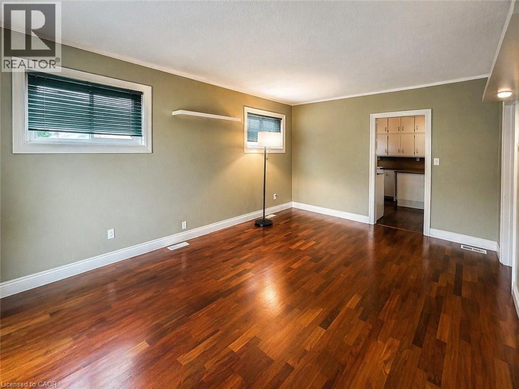 A room with wooden flooring and a window.
