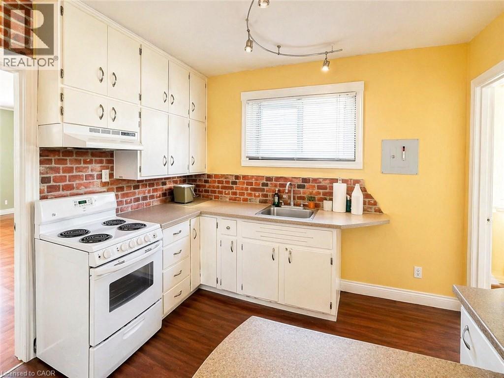 A kitchen with yellow walls and white appliances.