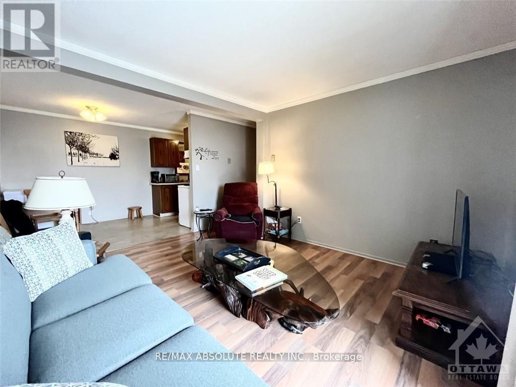 A living room with a grey couch and a red chair.