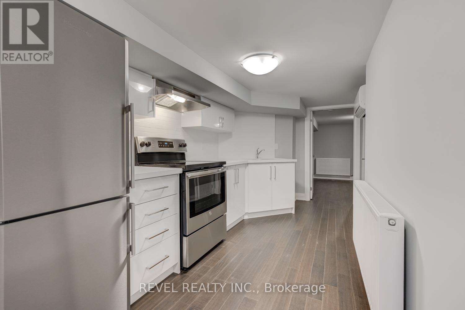 A kitchen with white appliances and cabinets.