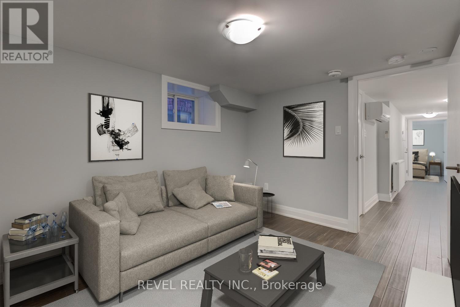 A living room with a grey couch and a coffee table.