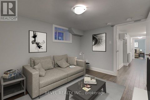 A living room with a grey couch and a coffee table.