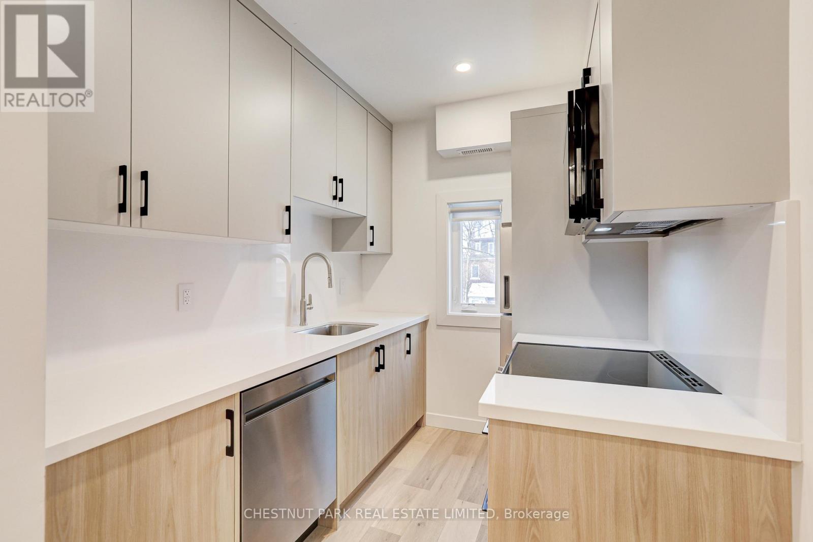 A modern kitchen with wooden cabinets and stainless steel appliances.