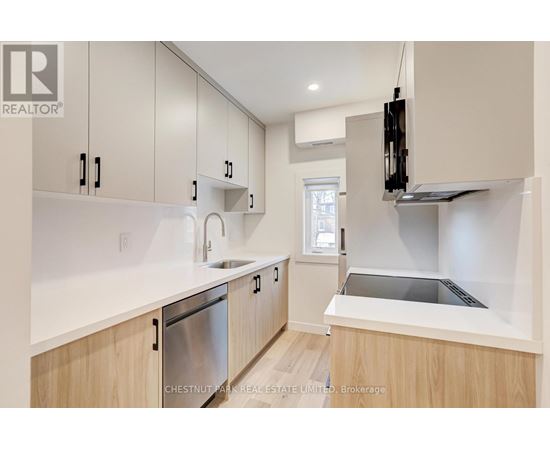 A modern kitchen with wooden cabinets and stainless steel appliances.