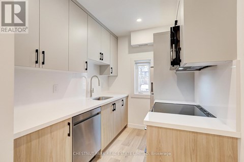 A modern kitchen with wooden cabinets and stainless steel appliances.