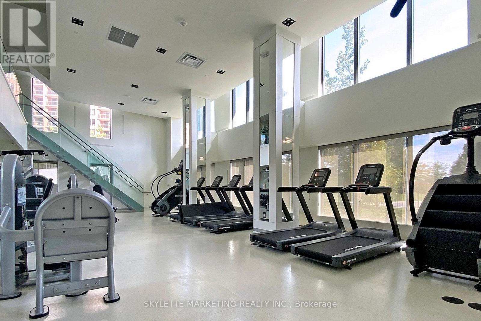 A gym with treadmills, elliptical machines, and a stair climber.