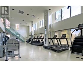 A gym with treadmills, elliptical machines, and a stair climber.