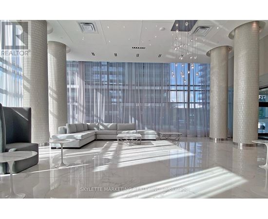 A modern living room with a large white sofa and a television.