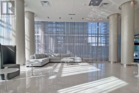 A modern living room with a large white sofa and a television.