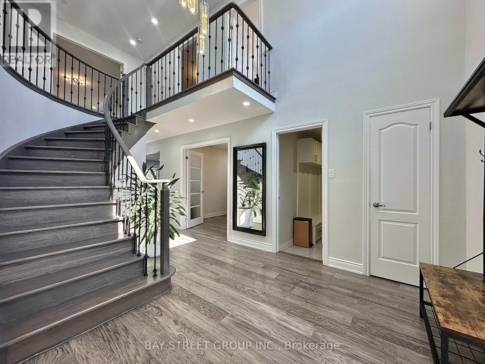 A spacious interior of a house with a staircase and a dining table.