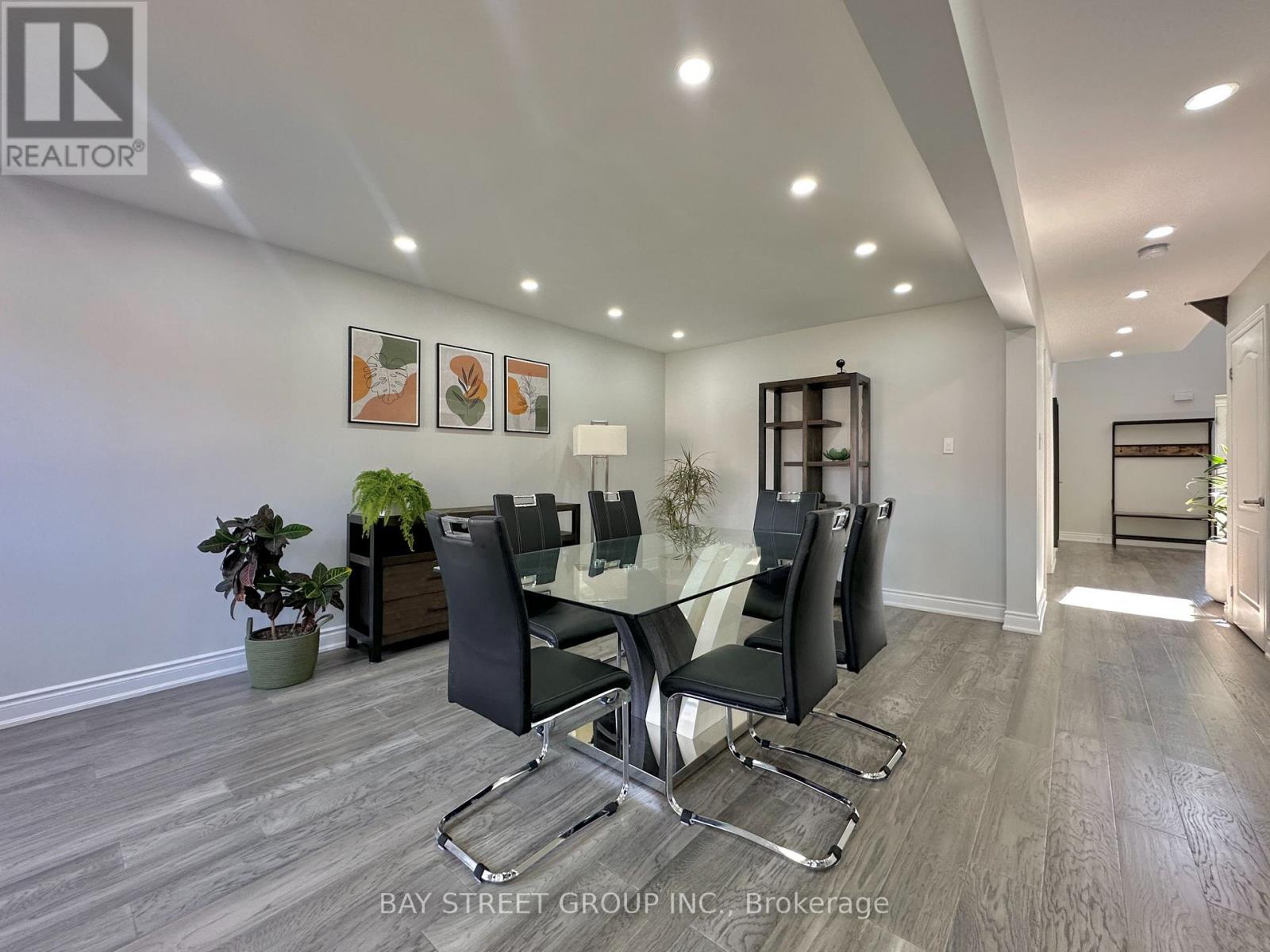 A dining room with a glass table and chairs.