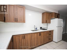 A kitchen with wooden cabinets and a white refrigerator.