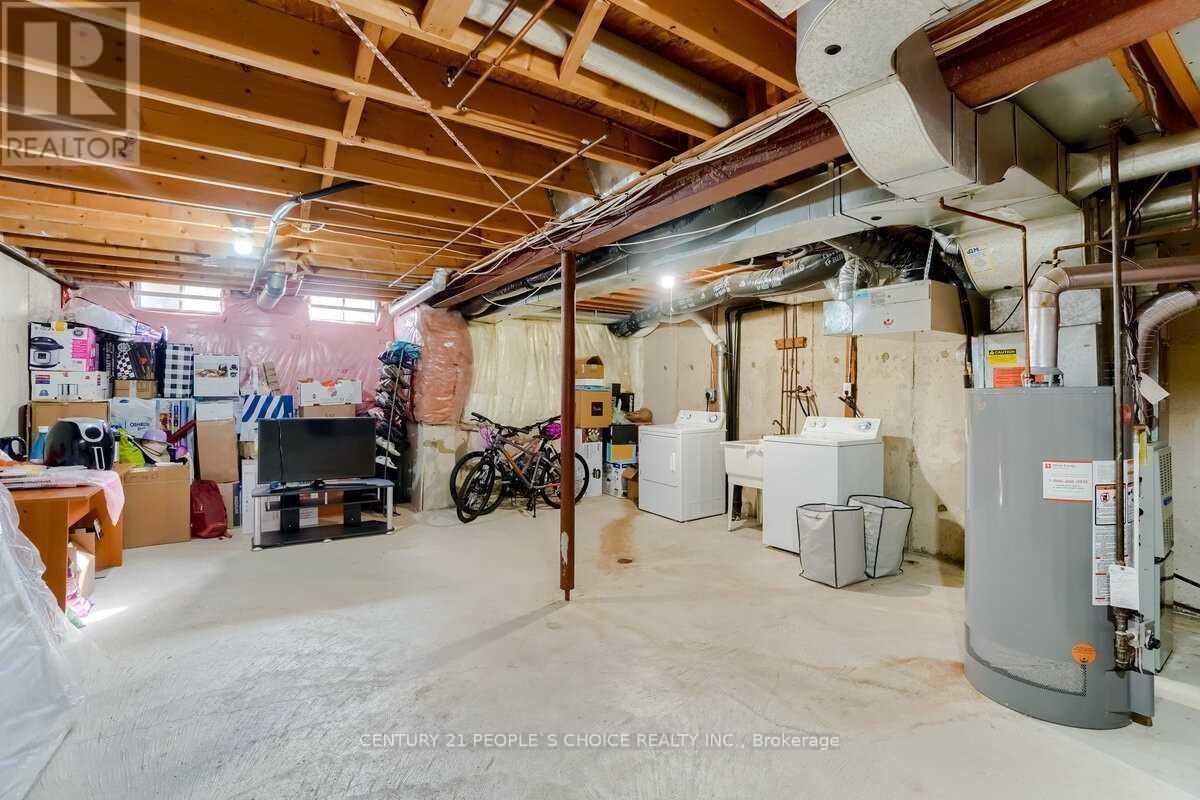 A sparsely furnished garage with a bicycle and a TV.
