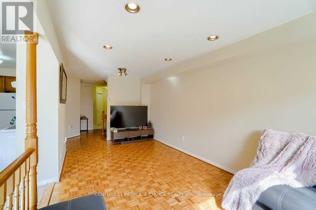 A living room with a television and a couch.