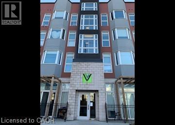 A tall building with a green logo on the front.