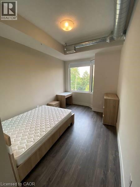 A bedroom with a large bed and a window.