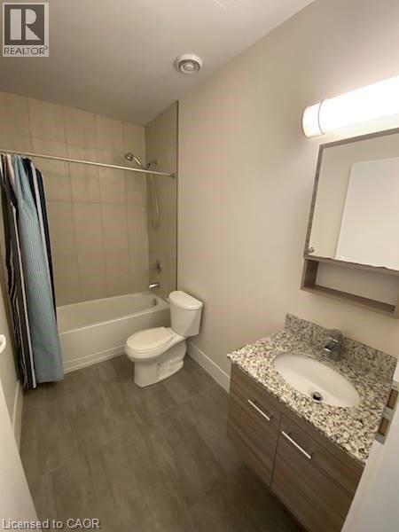 A bathroom with a toilet, sink, and bathtub.