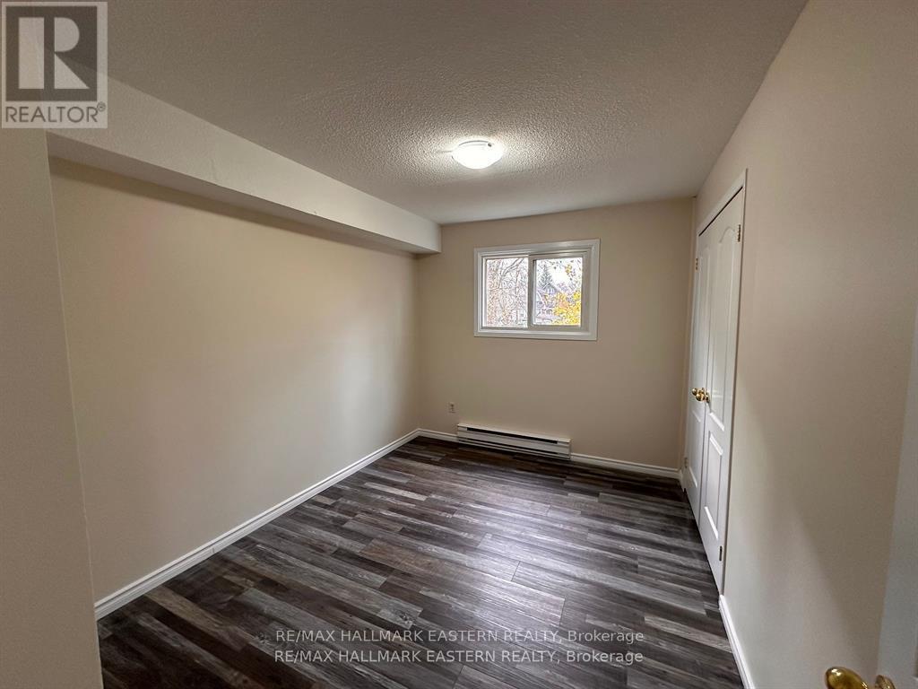 A room with a wooden floor and a window.