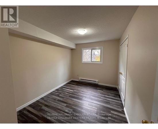 A room with a wooden floor and a window.