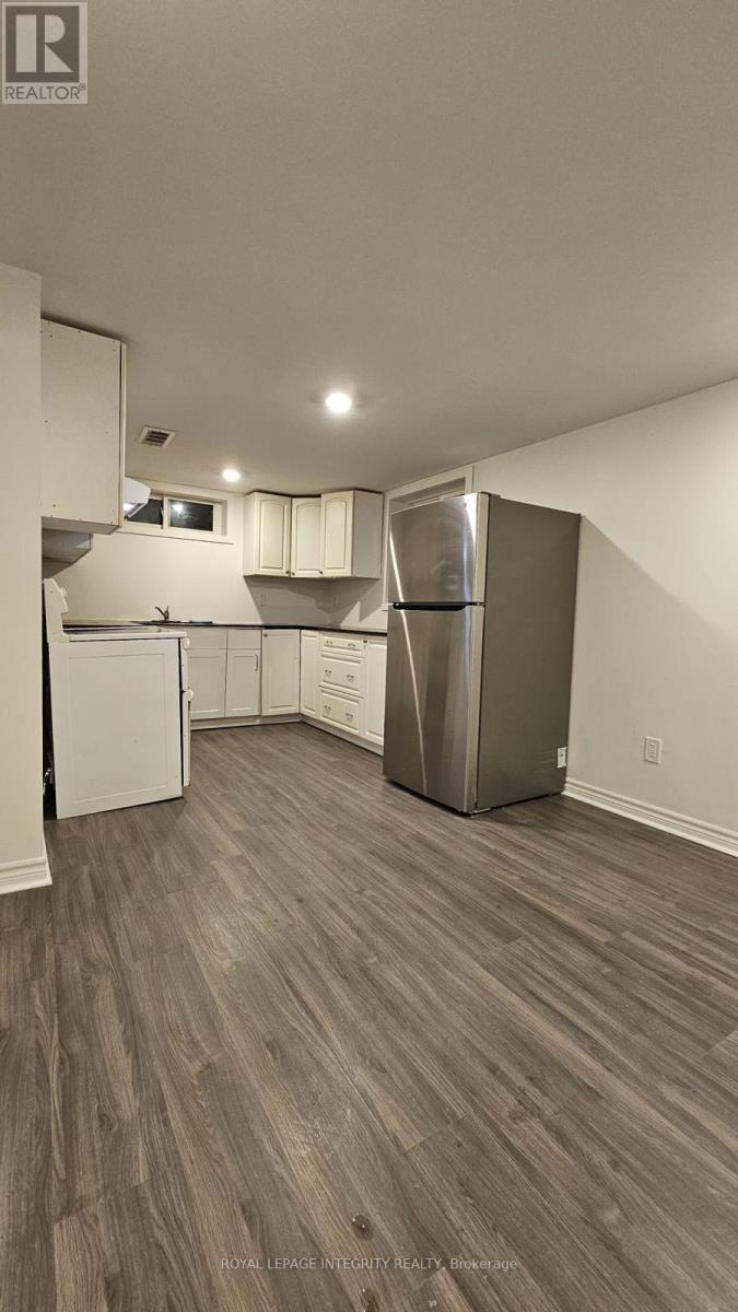A kitchen with a white refrigerator and a stainless steel refrigerator freezer.