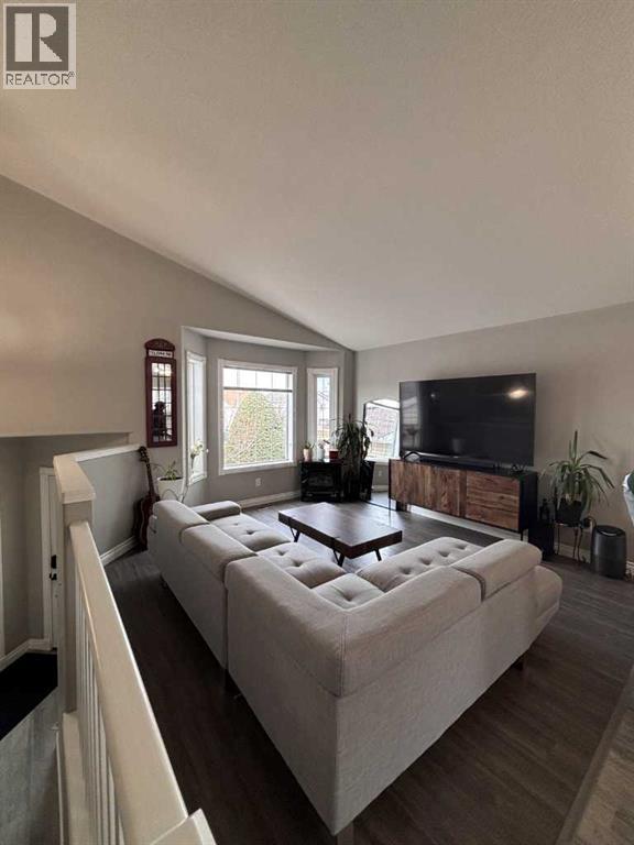 A living room with a large couch and a television.