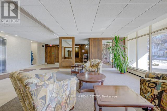 A living room with a couch, chairs, and a coffee table.