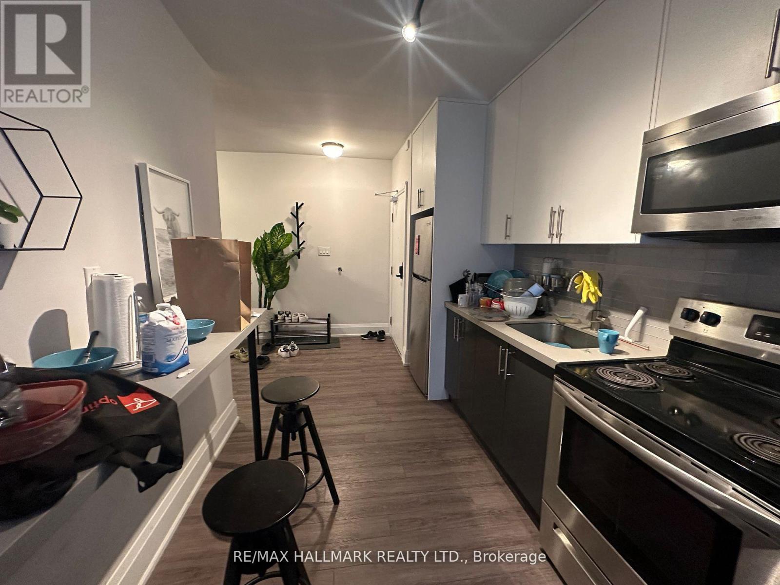 A kitchen with a stove top oven and a microwave.