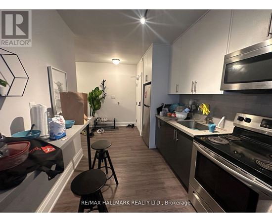 A kitchen with a stove top oven and a microwave.