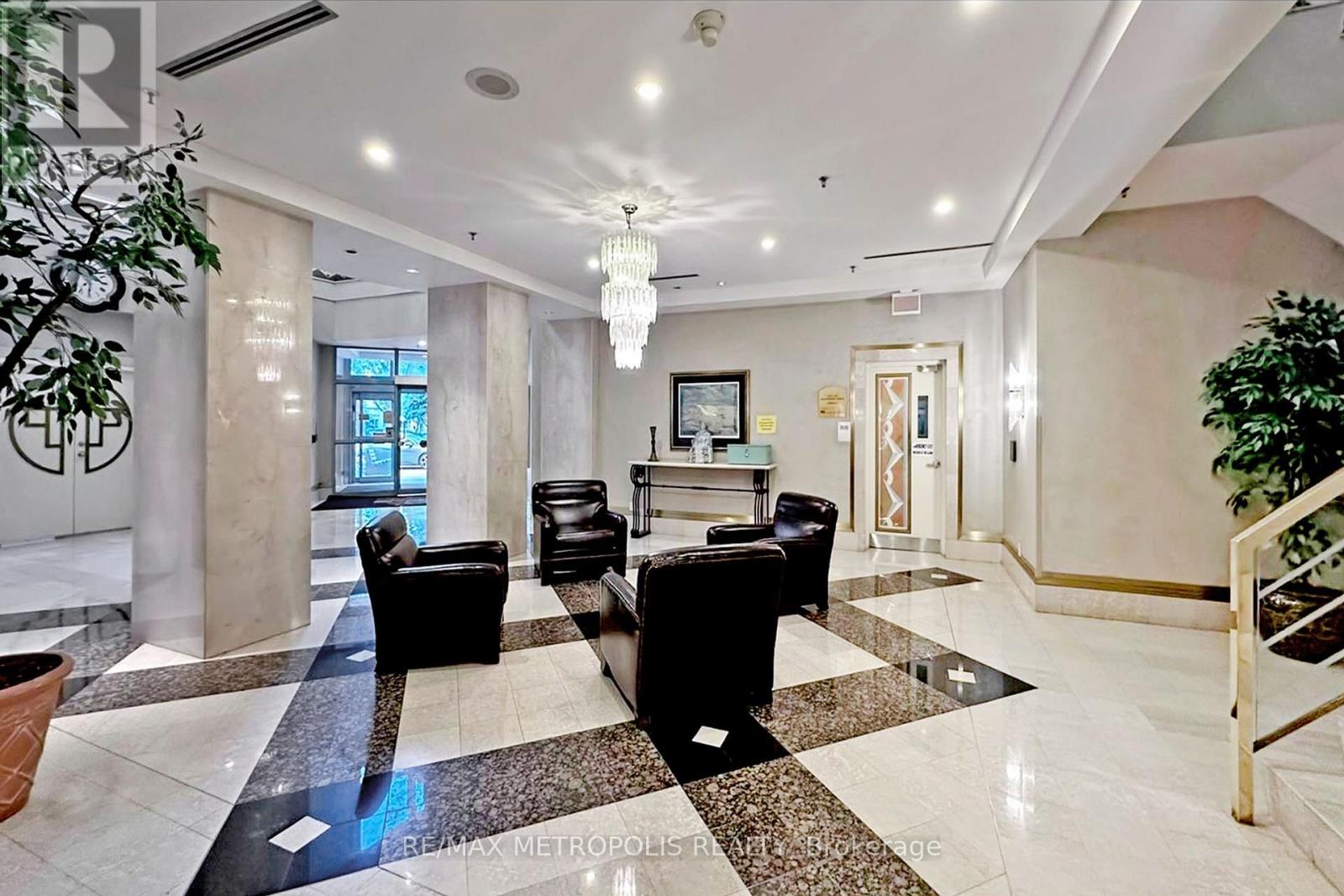 A spacious lobby with a black and white checkered floor.