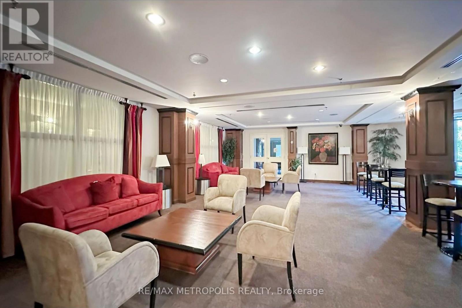 A spacious living room with a red sofa and a coffee table.