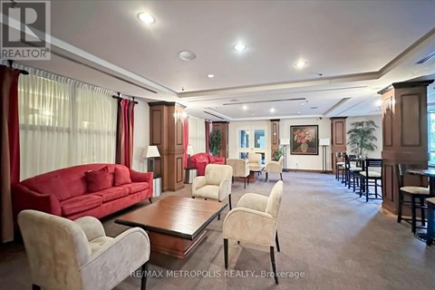 A spacious living room with a red sofa and a coffee table.