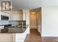 A kitchen with a granite counter top and a microwave above it.