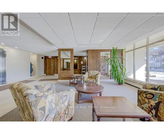 A living room with a couch, chairs, and a coffee table.