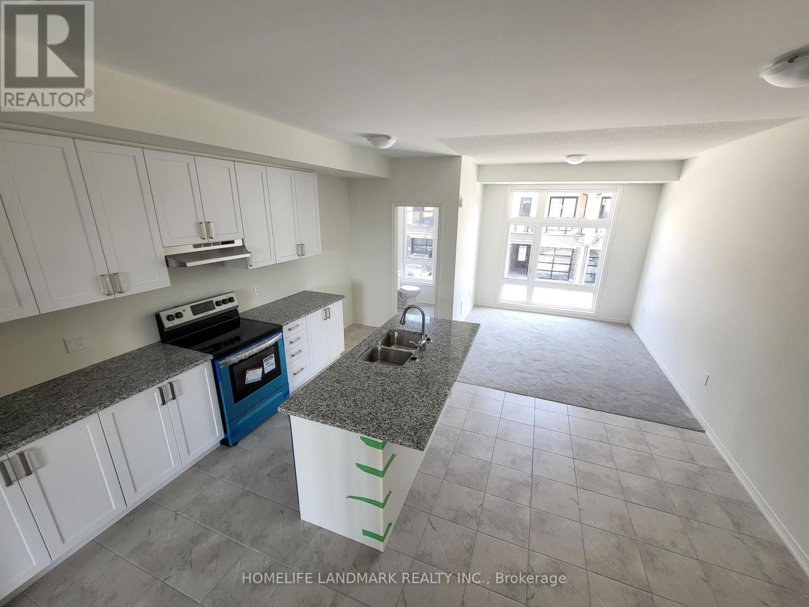 A kitchen with white cabinets and a blue oven.