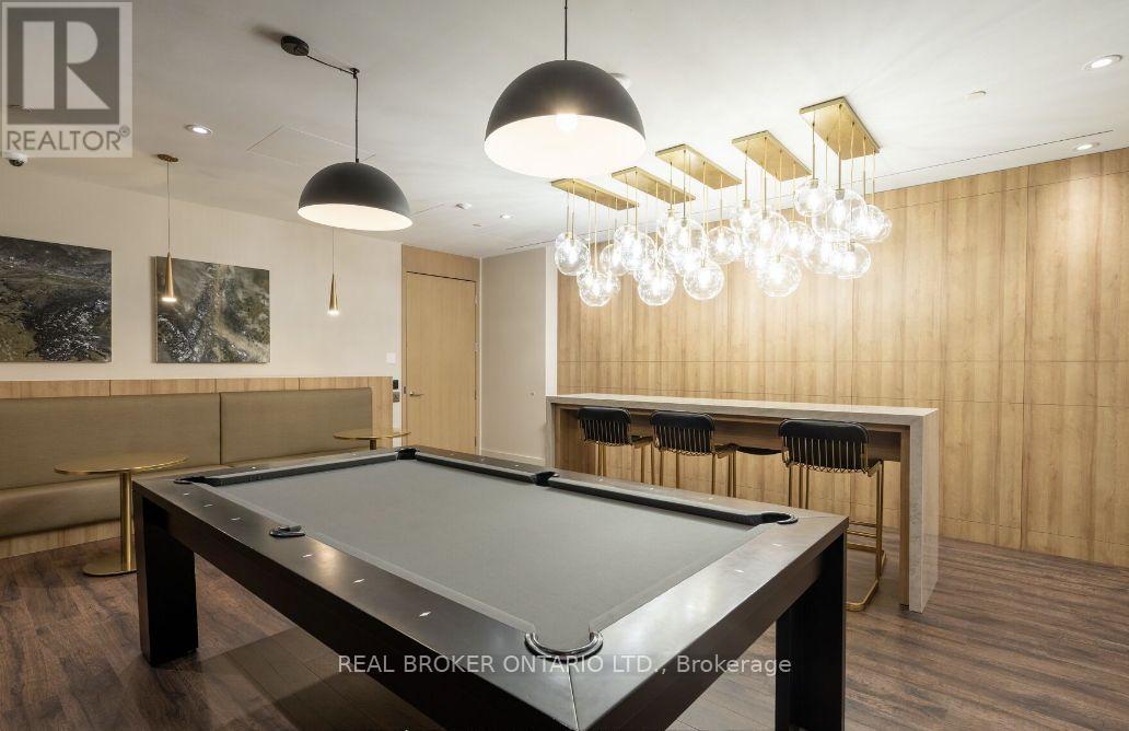 A pool table in a room with a billiard table and a bar.