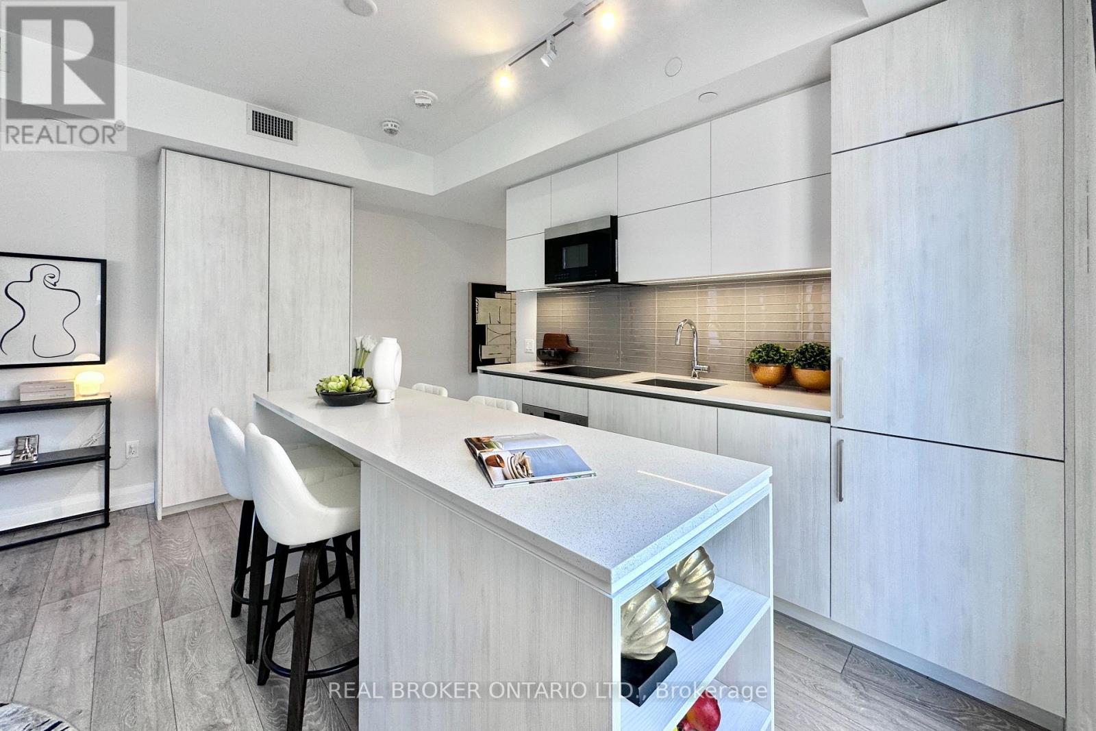 A modern kitchen with white cabinets and a central island.