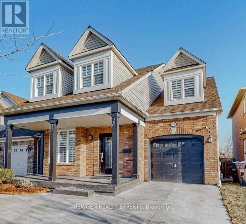 A house with a garage and a brick facade is for sale.