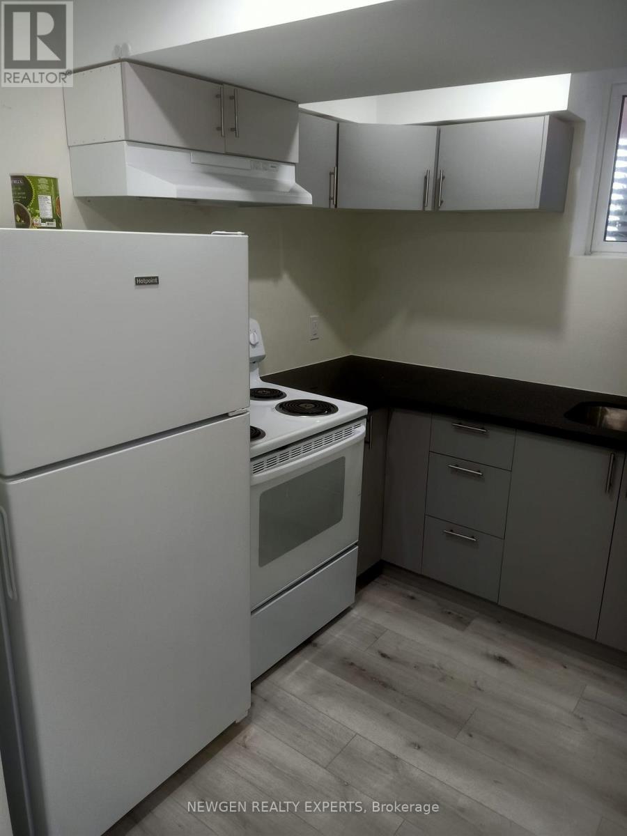 A white refrigerator and stove in a kitchen.