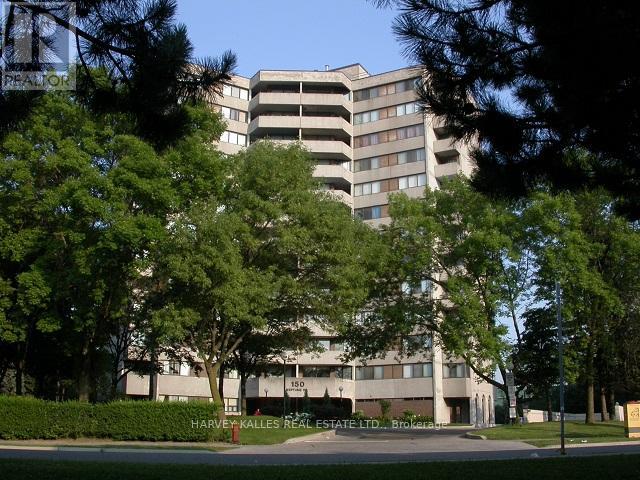 A large building with a parking garage in front of it.
