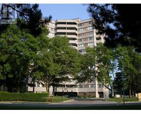 A large building with a parking garage in front of it.