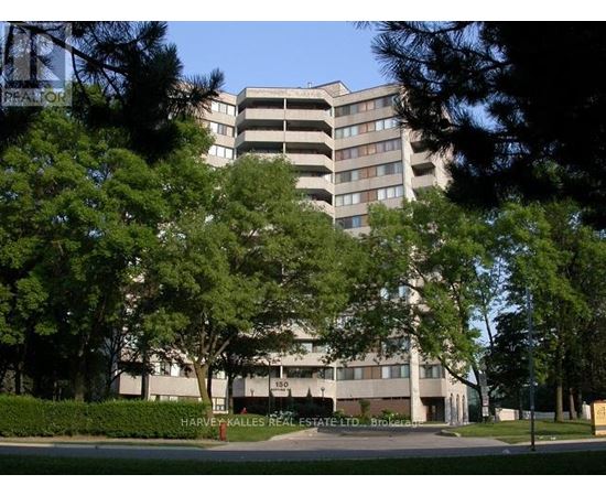 A large building with a parking garage in front of it.