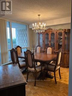 A dining room with a wooden table and chairs.
