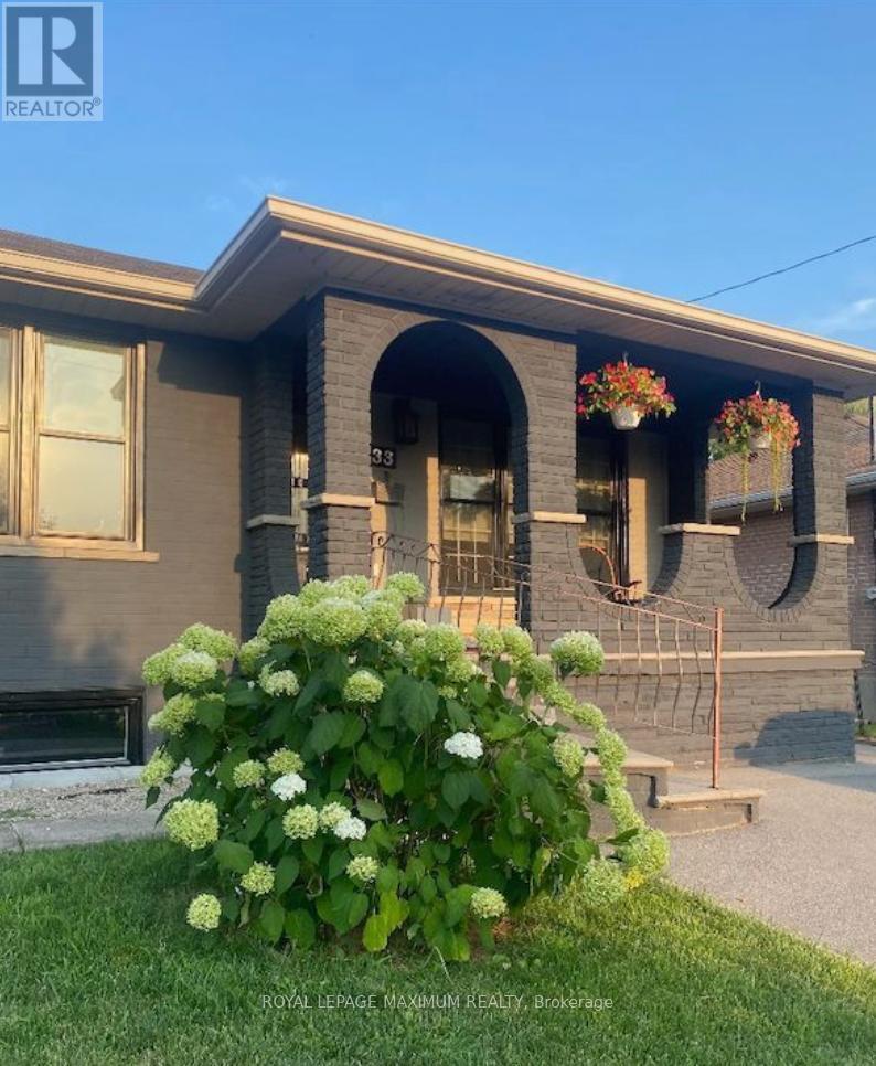 A house with a large front yard and a sign that says "REALTOR".