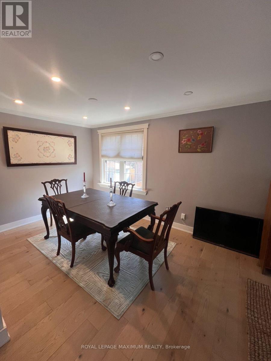 A dining room with a wooden table and chairs.