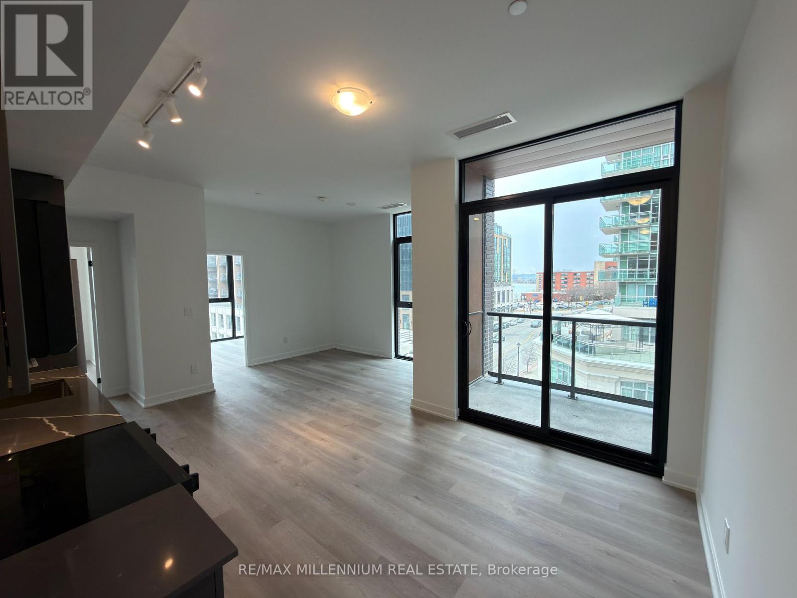 A spacious living room with a view of the city through large windows.