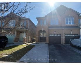 A sunny day at a residential area with houses and parked cars.